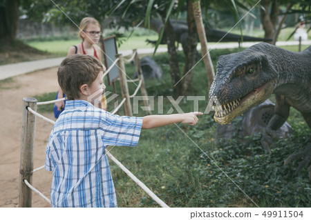 little boy playing in the adventure dino park. little boy playing in the adventure dino park. 49911504