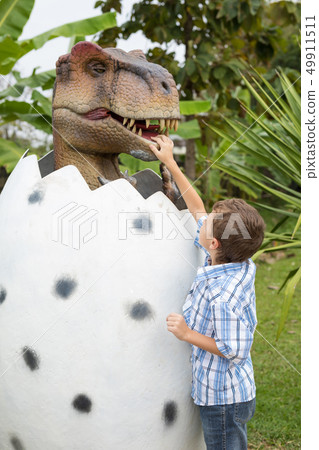 little boy playing in the adventure dino park. little boy playing in the adventure dino park. 49911511