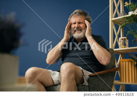 Old bearded man suffering from pain 49911628