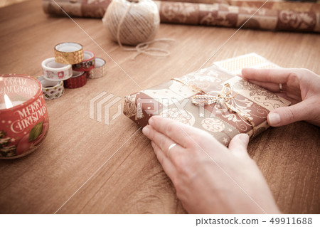 young woman packs gifts at the occasion of the occasion like birthday, valentin, wedding, new year's 49911688