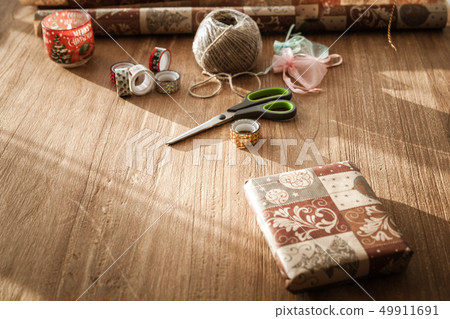 young woman packs gifts at the occasion of the occasion like birthday, valentin, wedding, new year's young woman packs gifts at the occasion of the occasion like birthday, valentin, wedding, new year's 49911691