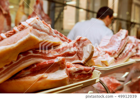 Cropped image of male butcher cutting raw meat 49912039
