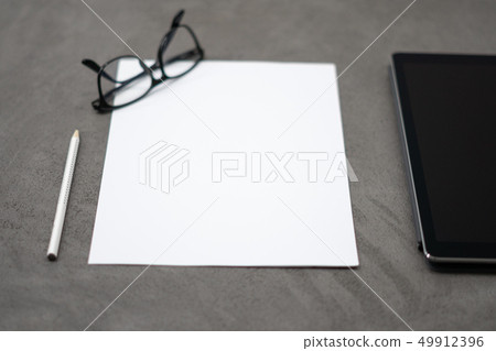 tablet with pen on a concrete table 49912396