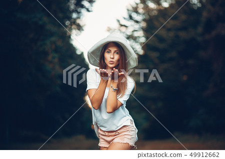 Yound and pretty girl in a summer park Yound and pretty girl in a summer park 49912662