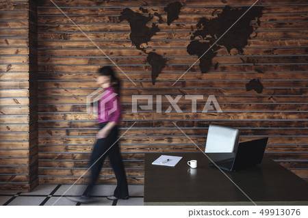 Blurred businesswoman walking to her desk Blurred businesswoman walking to her desk 49913076