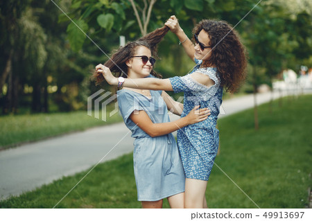 Two cute sisters in a summer park 49913697