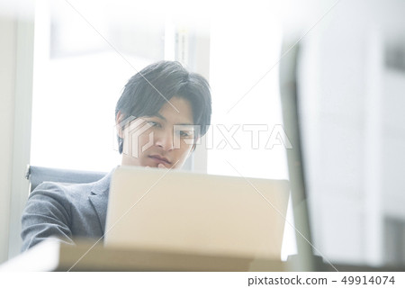 Young men working in the office Young men working in the office 49914074