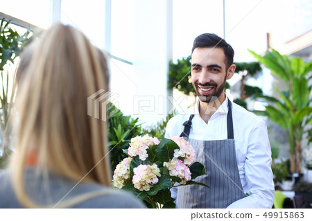 Smiling italian man seller of flowers stretches Smiling italian man seller of flowers stretches 49915863