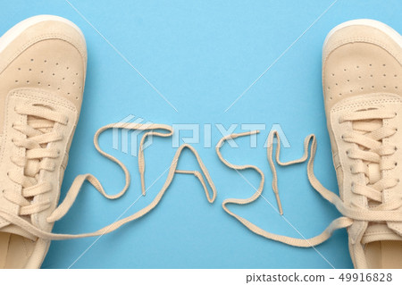 Women sneakers with laces in stash text. 49916828