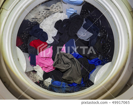 Top loading washing machine washes laundry. Top loading washing machine washes laundry. 49917065