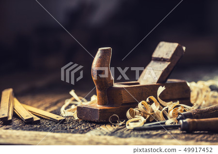 Old planer and other vintage carpenter tools in a 49917452