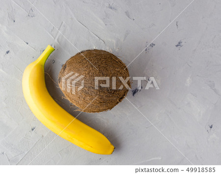 Banana and coconut on gray background. top view. Healthy vegan food concept 49918585