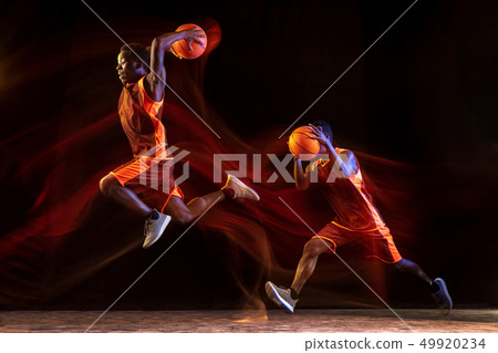 Young basketball player against dark background Young basketball player against dark background 49920234