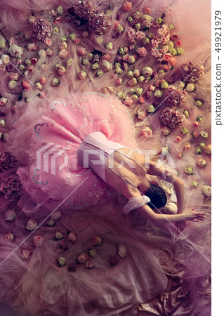 Young woman in pink ballet tutu surrounded by flowers Young woman in pink ballet tutu surrounded by flowers 49921979