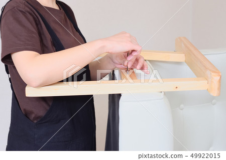 Woman assembling and disassembling a sofa 49922015