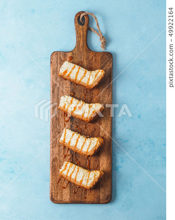 cheesekace pieces on cutingboard over blue cheesekace pieces on cutingboard over blue 49922164