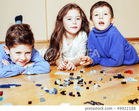 funny cute children playing toys at home, boys and girl smiling, first education role close up funny cute children playing toys at home, boys and girl smiling, first education role close up 49922188