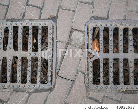 two city sewer grids on a pavement for rain water 49922638