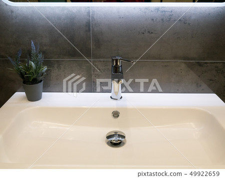 closeup of modern white washbasin with lavender closeup of modern white washbasin with lavender 49922659