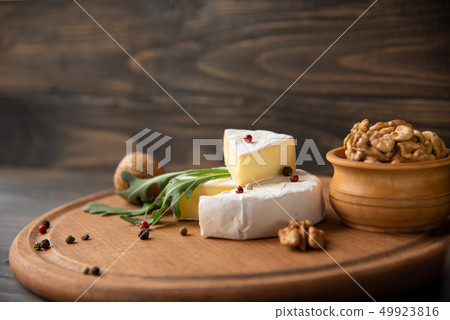 Cheese camembert or brie with walnuts and arugula Cheese camembert or brie with walnuts and arugula 49923816