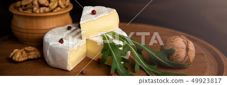 Cheese camembert or brie with walnuts and arugula Cheese camembert or brie with walnuts and arugula 49923817