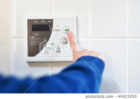 Woman doing bathing with a kitchen remote control 49923859