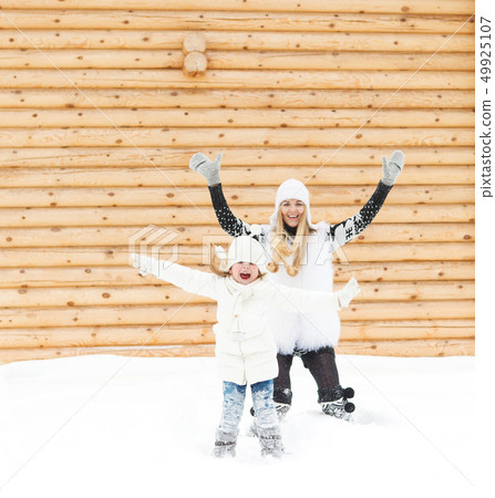 Happy mother with her daughter jumping outdoors Happy mother with her daughter jumping outdoors 49925107