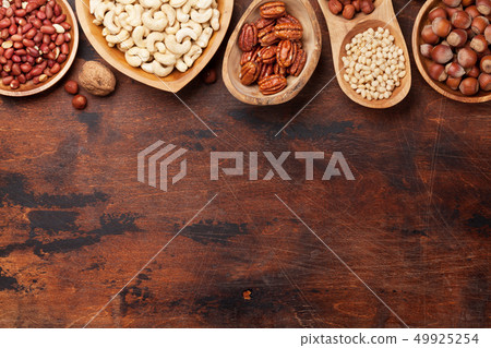 Various nuts selection on wooden table 49925254