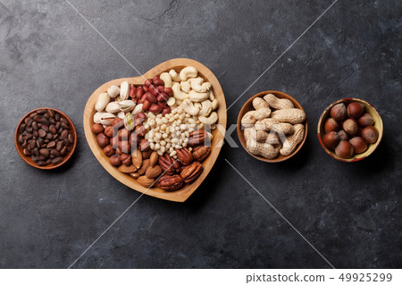 Various nuts selection on stone table 49925299