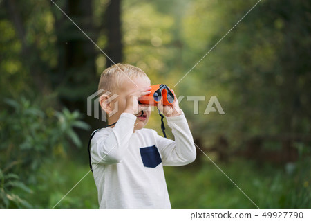 The little boy and orange binoculars The little boy and orange binoculars 49927790