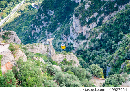 Yellow cable car in the Aeri de Montserrat rise to Yellow cable car in the Aeri de Montserrat rise to 49927934
