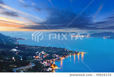 Night summer coastline and village  on seashore 49928154