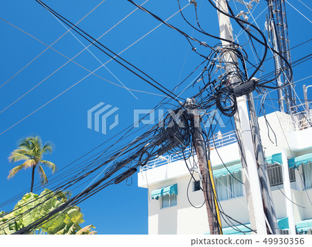 Electric tower with untidy cables and wires on 49930356