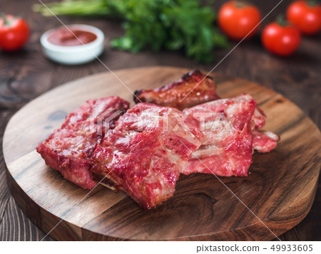 pork ribs on wooden plate 49933605