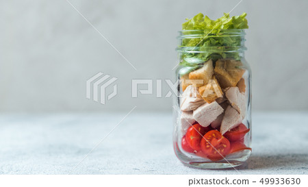 Caesar salad in glass mason jar, copy space 49933630
