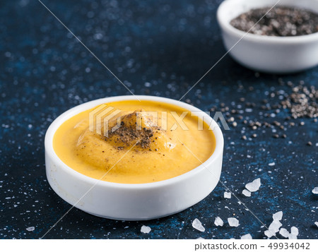 Vegan creamy cheddar cheese sauce with chia seeds 49934042