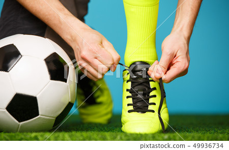 Soccer player tying his shoes 49936734