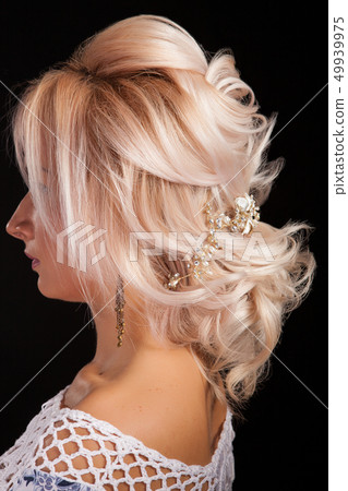 Close up shot of beautiful coiffure on a blonde woman isolated on black background 49939975