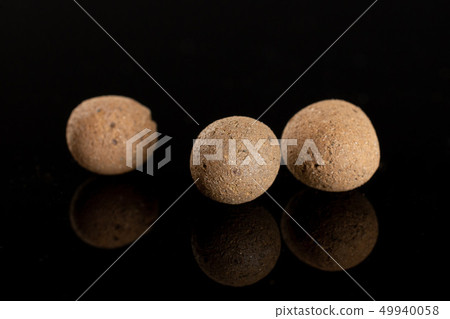 Clay pebbles (leca) isolated on black glass Clay pebbles (leca) isolated on black glass 49940058