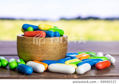 Licorice sweet comfit with field behind Licorice sweet comfit with field behind 49940315
