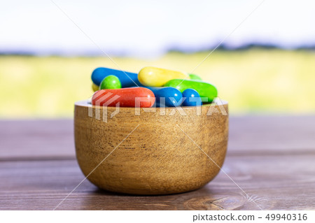 Licorice sweet comfit with field behind Licorice sweet comfit with field behind 49940316