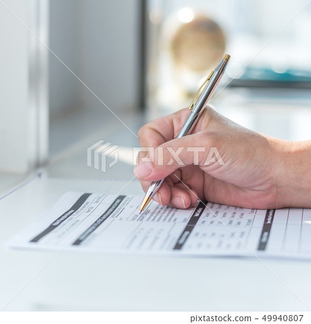 Physician doctor writing on medical care record Physician doctor writing on medical care record 49940807