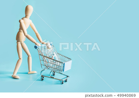 Buyer as doll with grocery trolley with vodka Buyer as doll with grocery trolley with vodka 49940869