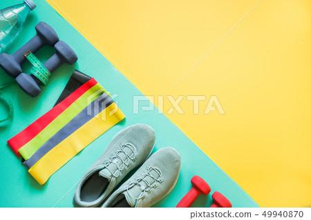 Fitness equipment, dumbbells, rubber band. Fitness equipment, dumbbells, rubber band. 49940870