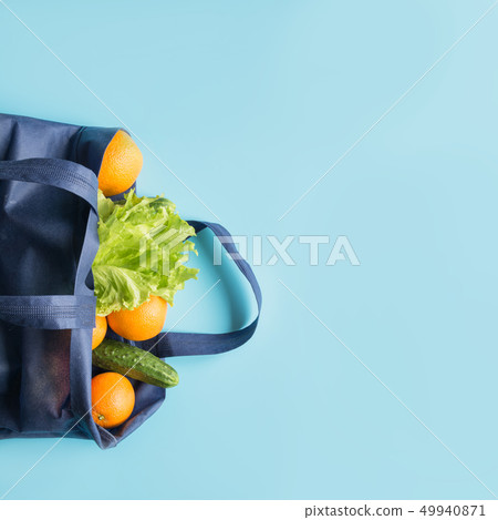 Zero waste concept. Blue shopping bag with orange Zero waste concept. Blue shopping bag with orange 49940871