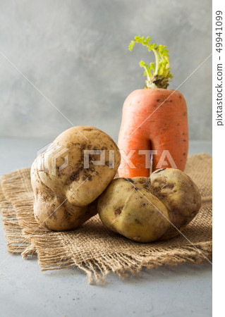 Ugly organic carrot and potatoes. Space for text. 49941099