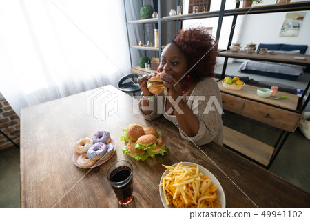 Positive delighted international woman spending time at home Positive delighted international woman spending time at home 49941102