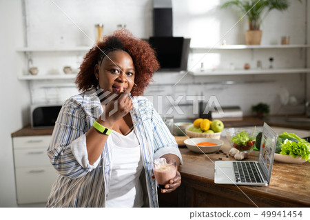Hungry dark-skinned female person looking at camera 49941454