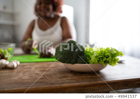 Positive delighted international woman enjoying domestic life Positive delighted international woman enjoying domestic life 49941537