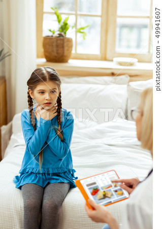 Little girl cuddling her hands near a throat. Little girl cuddling her hands near a throat. 49941607